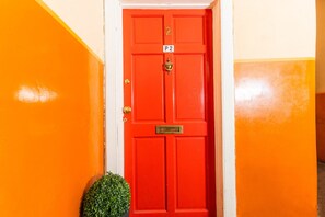 Enter through the door marked P2, featuring a brass handle and a small brass plate.