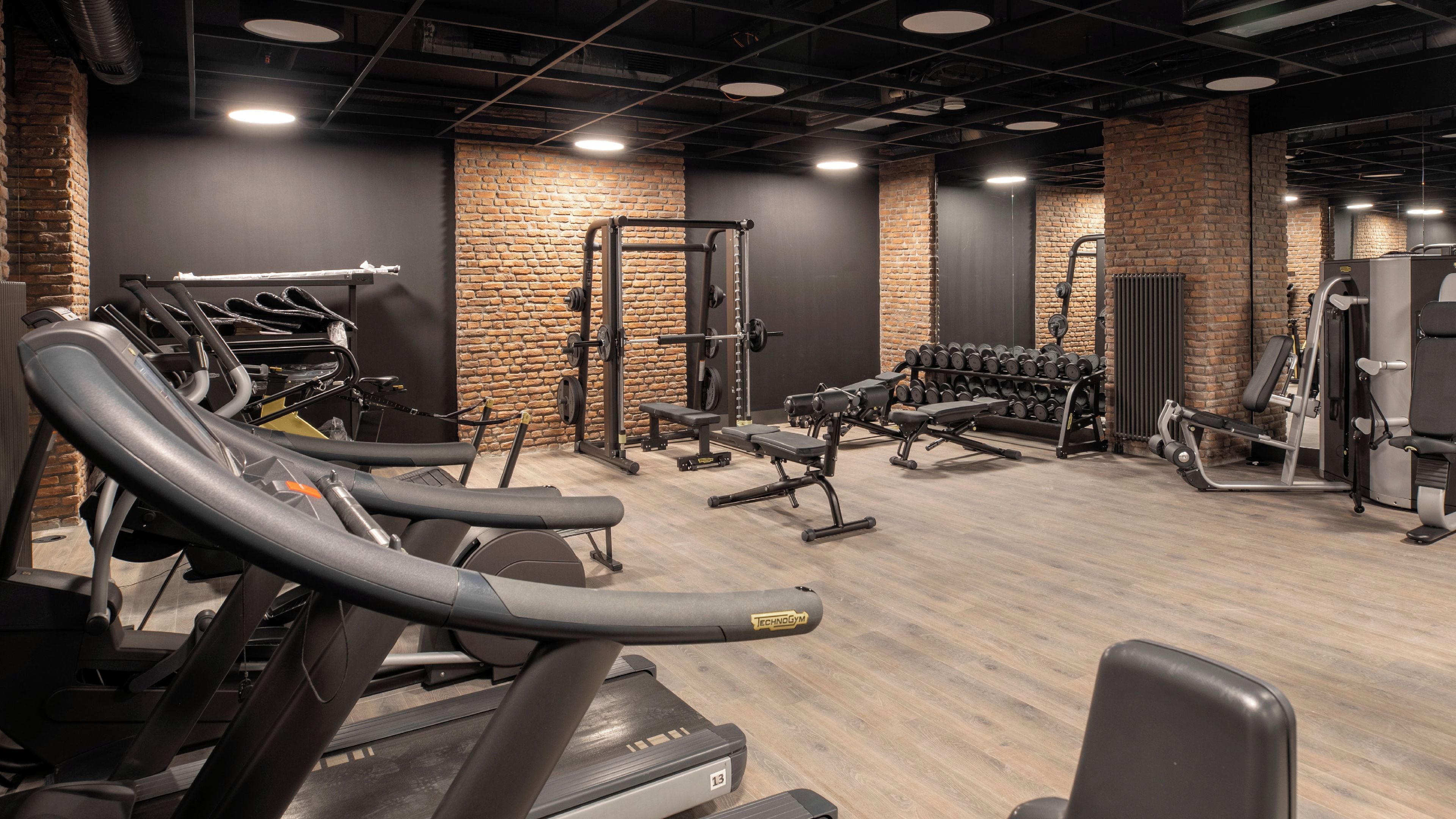 A gym with treadmills, weight machines, and free weights.