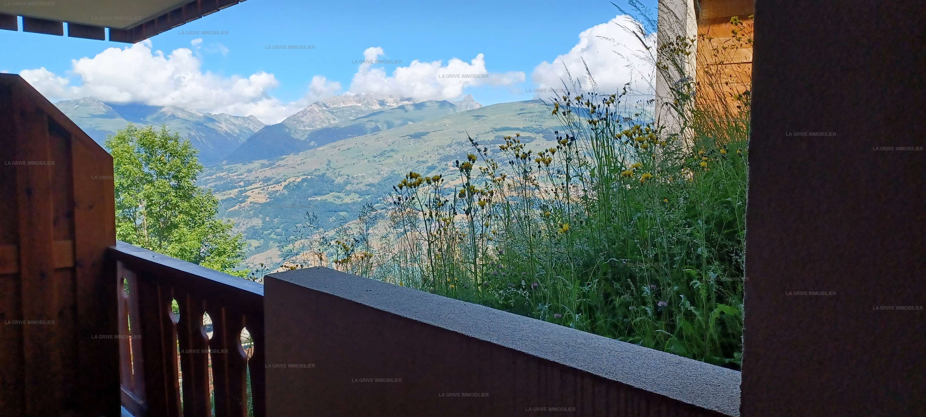 A balcony with a view of a mountainous landscape.