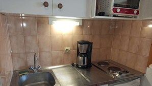 A compact kitchen with a sink, a coffee maker, a dishwasher, and a microwave. - Paradiski closed to the slopes vallandry (LANDRY)