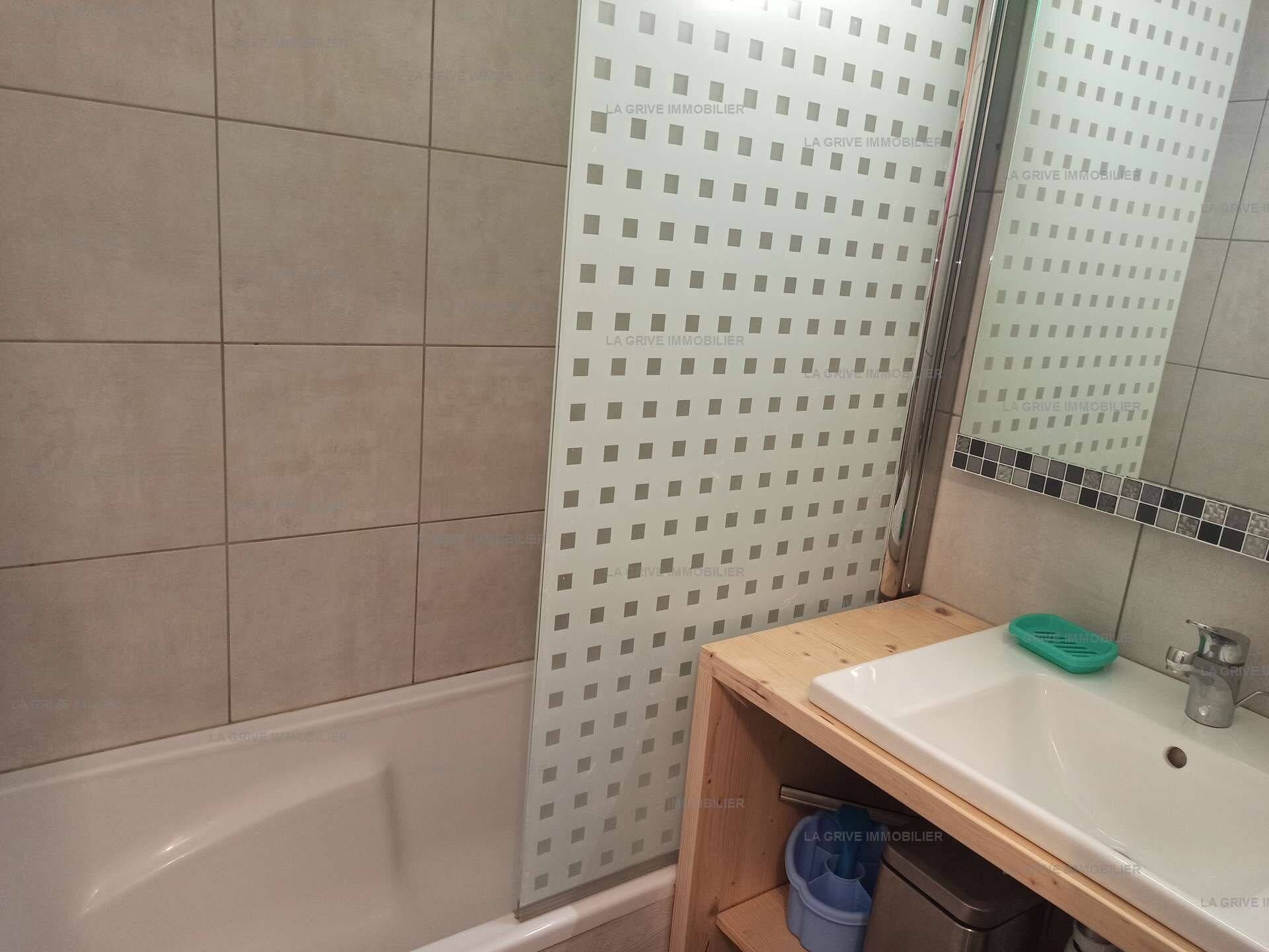 Un baño con bañera, lavabo y espejo.