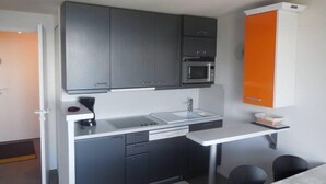A modern kitchen with grey cabinets, a built-in microwave, and a white countertop. - Paradiski closed to the slopes vallandry (LANDRY)