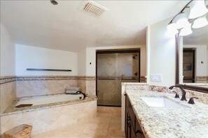 A bathroom with a large bathtub, a separate shower area, and a vanity with a sink and mirror. - Luxury at its Finest - 3306 Towers - Traffic Free Beach - 3/3 Oceanfront (Ponce Inlet)