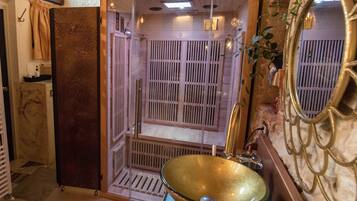 Bathroom features a unique sink, ornate mirror, and textured walls.