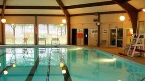 An indoor swimming pool with clear lanes, large windows, and a wooden ceiling structure. - Your Best Vacation is waiting at the Sage Chalet - Close to Kalahari & Camelback (Long Pond)