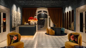 A luxurious lobby with a checkered floor, a central bar area, and seating with floral cushions. - Montebelo Vista Alegre Lisboa Chiado, member of Preferred Hotels & Resorts (Lisbon)