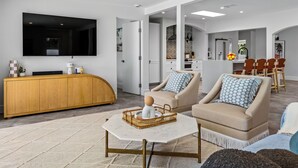 A modern living room with a TV, sofa, and coffee table.