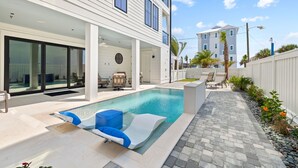 A modern house with a swimming pool, outdoor seating, and a covered patio area. - Emerald View|Easy Beach Access|Unobstructed Gulf Views|Private Pool (Inlet Beach)