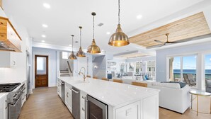 A modern kitchen with a large island, stainless steel appliances, and pendant lighting. - Emerald View|Easy Beach Access|Unobstructed Gulf Views|Private Pool (Inlet Beach)