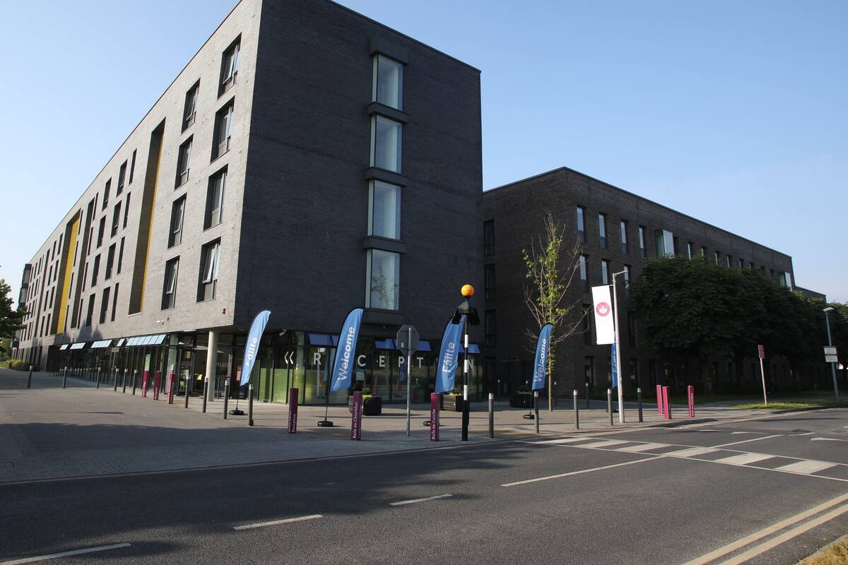 A modern building with a flat facade, multiple windows, and a welcoming entrance.