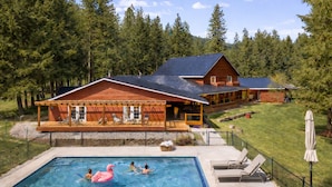 A cabin with a pool, surrounded by a forest. - River Road Lodge 7 Bedroom Lodge by NW Comfy Cabins by RedAwning (Leavenworth)