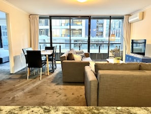 Relax in this urban retreat with a city view, comfortable sofa, and dining area.