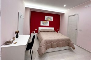 A bedroom with a bed, a desk, a chair, and a wardrobe. - DOMUS BALCANTE (Pompei)