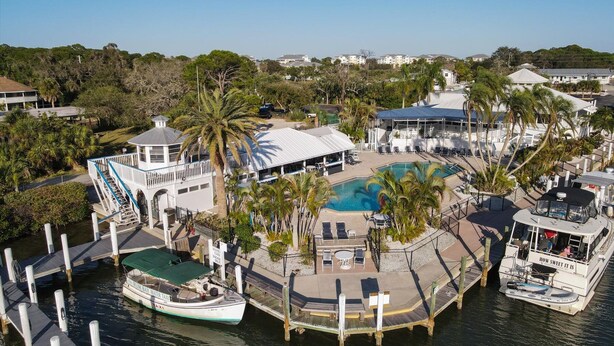 A waterfront property with a swimming pool, a boat dock, and a boat named 'HOW SWEET IT IS'. - Manatee Harbor: Marina, Heated Pool-Spa, Island Ferry with PRIVATE Beach access! (Placida)