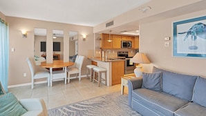 A compact living space with a dining area, kitchenette, and a sofa. - Manatee Harbor: Marina, Heated Pool-Spa, Island Ferry with PRIVATE Beach access! (Placida)