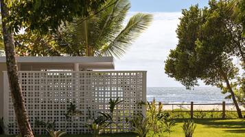 A white lattice fence with a view of the ocean.