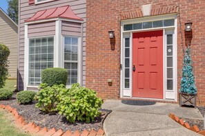A house with a red door, a brick facade, and a small Christmas tree. - 4 Mi to Chattahoochee River: Family Home w/ Yard! (Roswell)