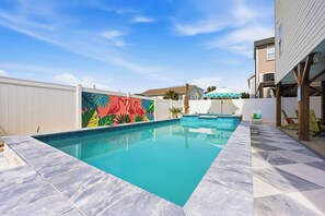 A swimming pool with a tiled deck, a colorful mural, and a white fence. - 2 blocks 2 beach, Golf Cart, Outdoor Bar, Dogs Welcome, Beach Gear (Atlantic Beach)