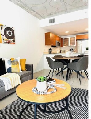 Relax in a cozy living space with a comfortable sofa, dining area, and well-equipped kitchen.