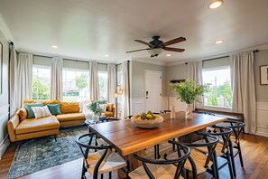 Relax in this inviting living area with a large dining table and comfortable sofa.