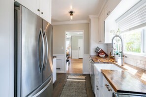 Enjoy cooking in this well-lit kitchen with ample counter space and sleek appliances.
