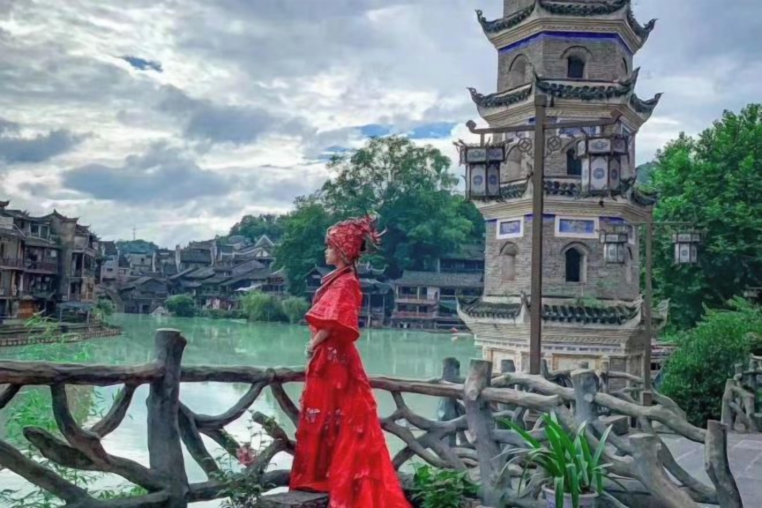 A traditional Chinese pagoda with intricate architecture, a wooden bridge, and a calm water body in the background.