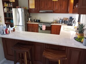 Enjoy cooking in this well-appointed kitchen with a refrigerator, oven, microwave, and coffee maker.