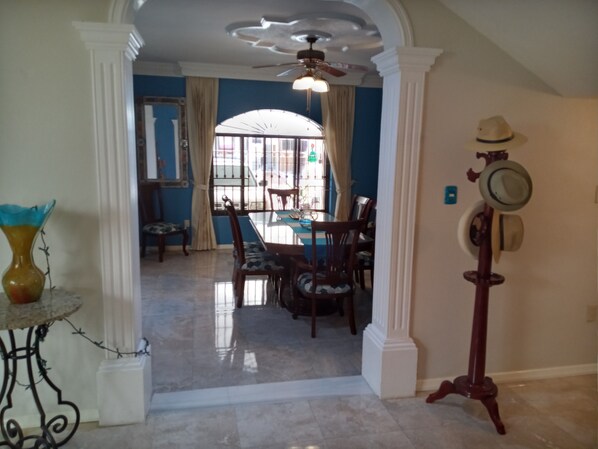 Relax in this serene space with a dining area, ceiling fan, and comfortable seating.