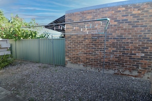 Guests can enjoy an outdoor space with a brick wall and metal gate.