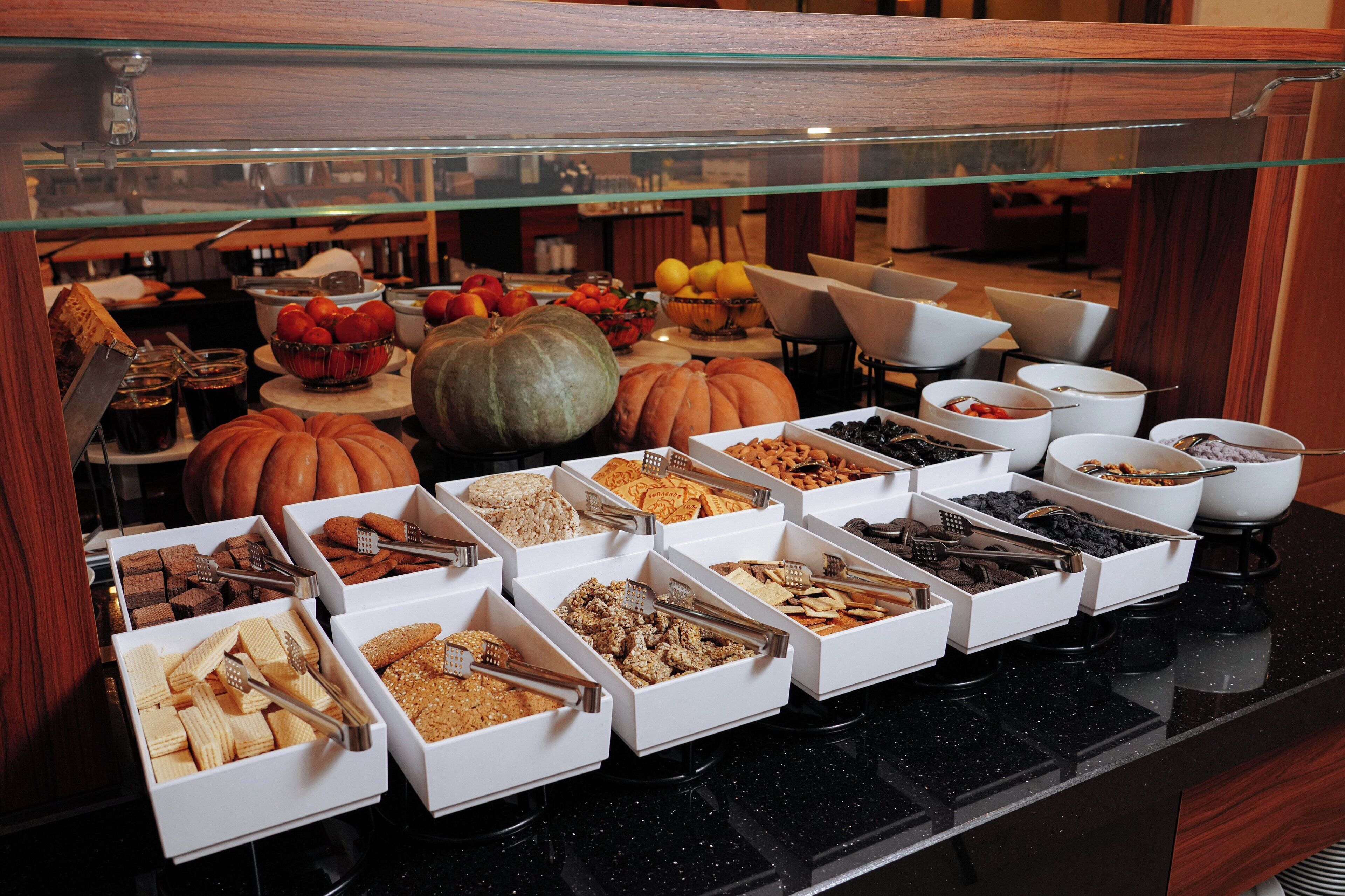 A buffet with various food items and a glass display case.