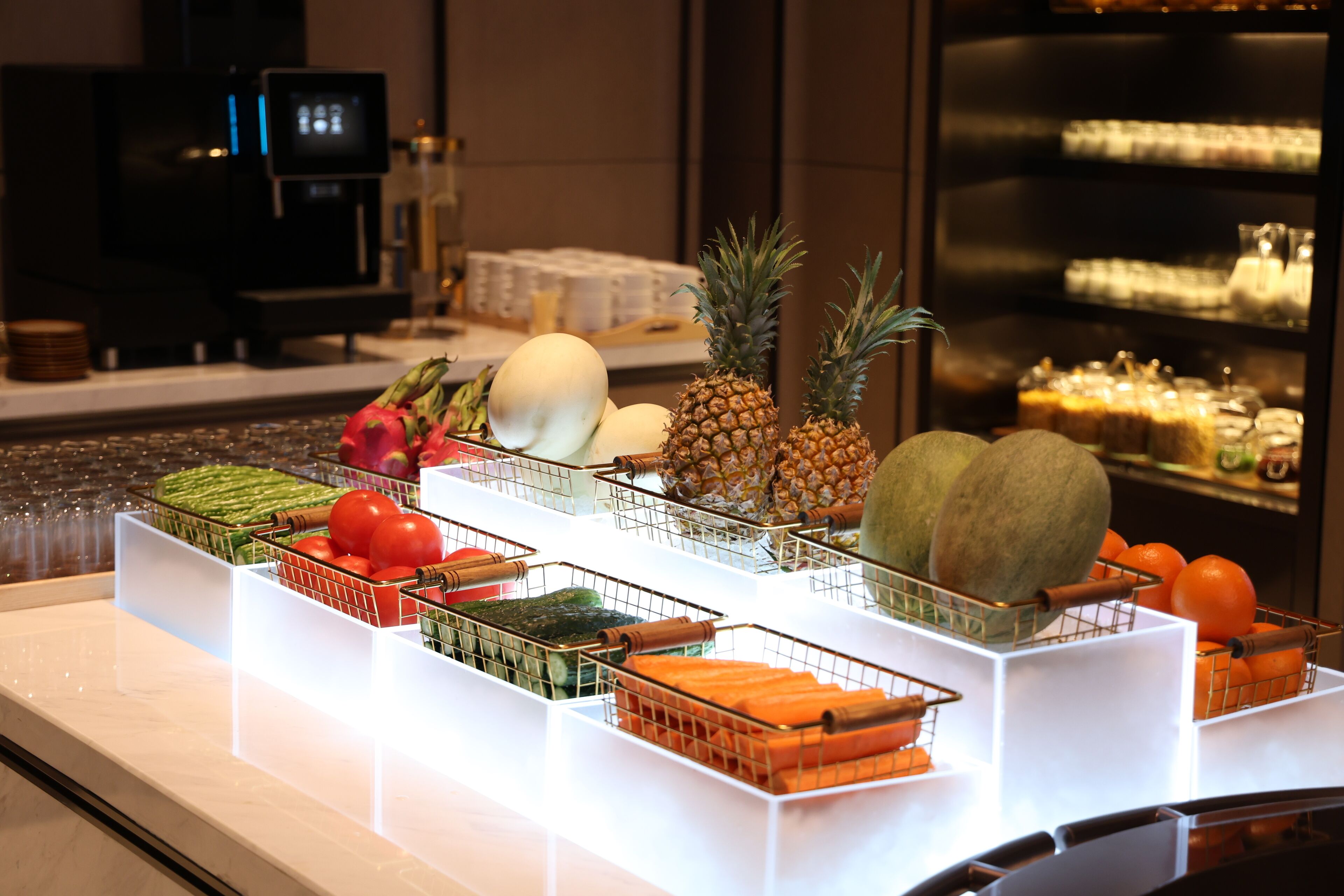 A fruit display with various fruits like pineapple, melon, and oranges.