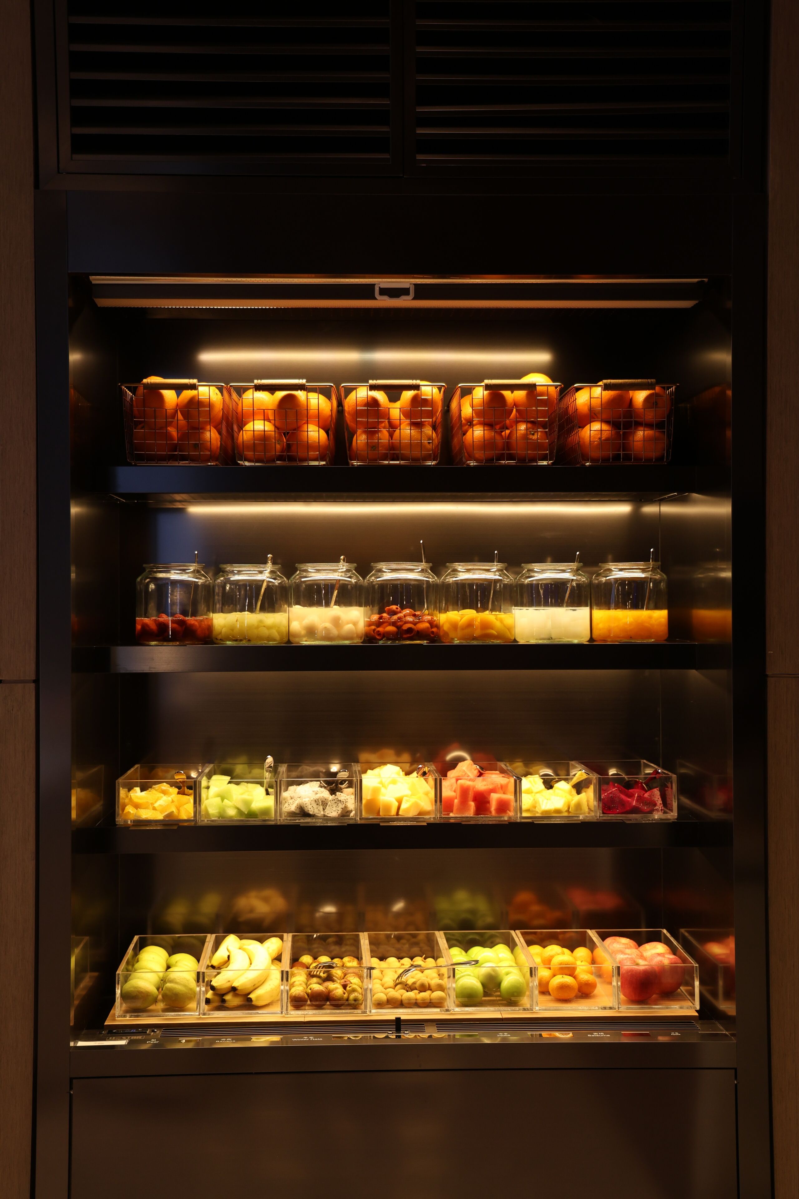 A refrigerated display case with various fruits and vegetables.