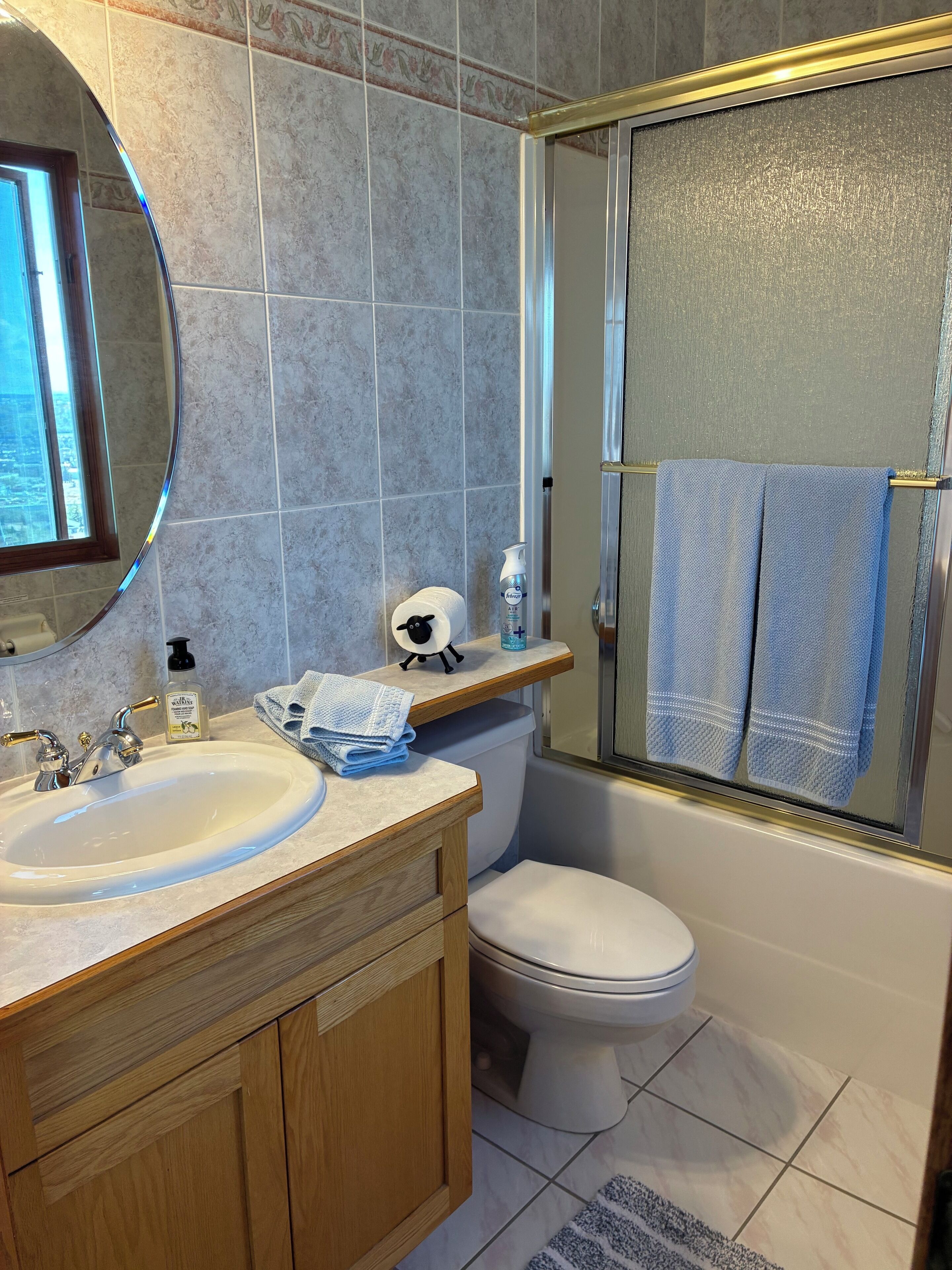 A bathroom with a sink, toilet, and shower.