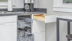 A modern kitchen with white cabinets, a built-in coffee maker, and a dishwasher. - Gambier I MountVernon I BikePath (Mount Vernon)
