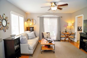 A living room with a sofa, coffee table, and a television. - The Downtown Napa Getaway (Napa)