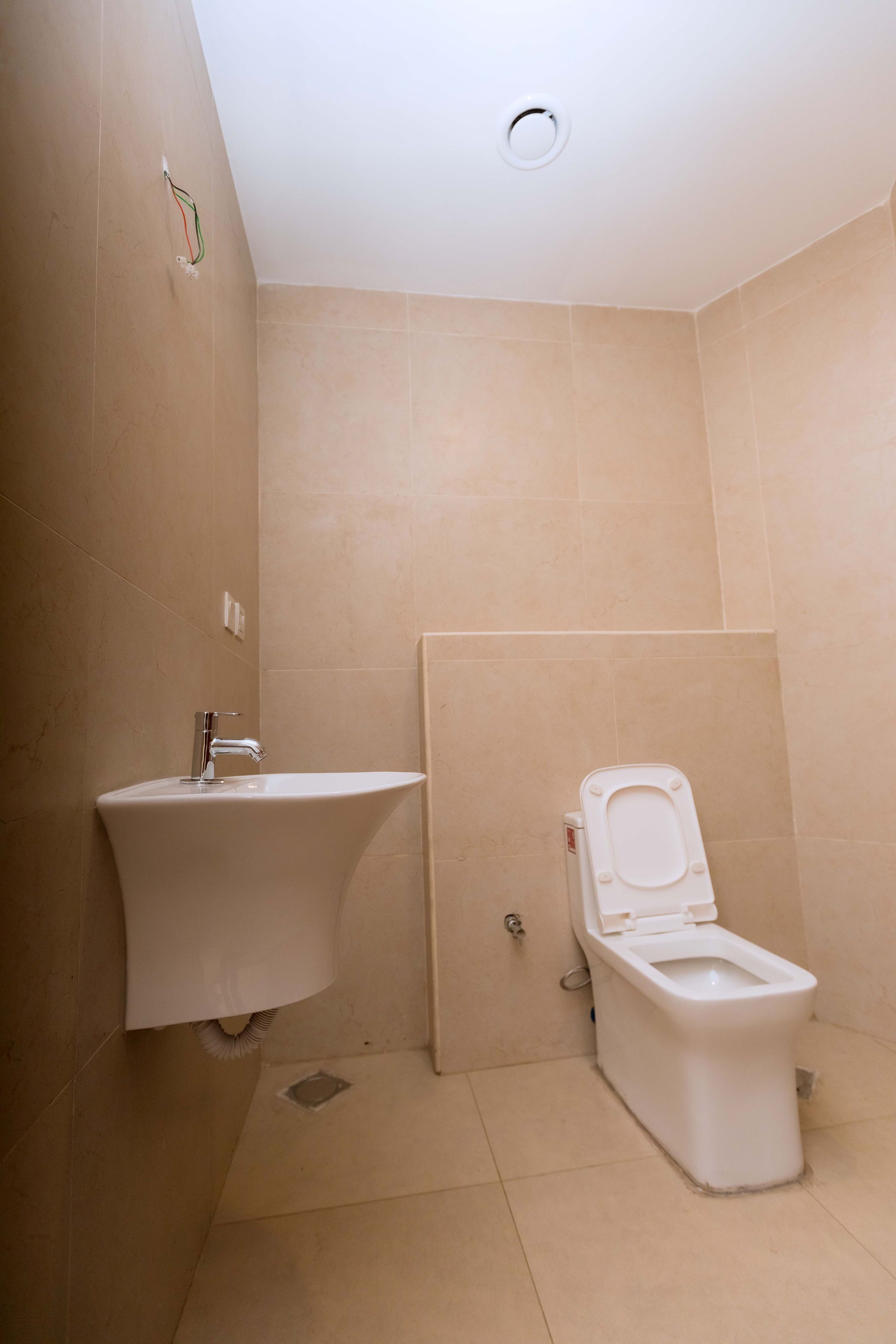 A bathroom with a sink, toilet, and a shower area.