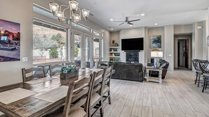 A spacious living area with a dining table, chairs, a sofa, and a TV. - Experience luxury at Sedona Thunder Mountain Estate and Casita in West Sedona. (Sedona)
