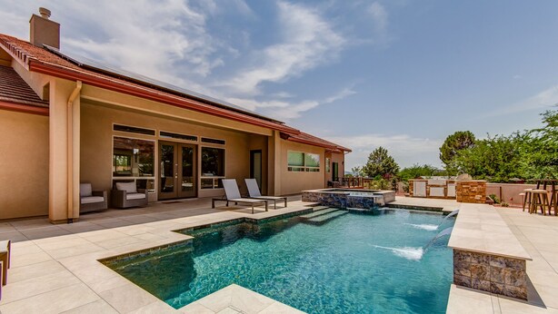 A modern house with a swimming pool, outdoor seating, and a barbecue area. - Experience luxury at Sedona Thunder Mountain Estate and Casita in West Sedona. (Sedona)