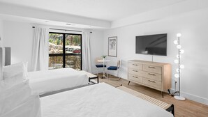 A modern hotel room with two beds, a desk, a dresser, and a TV. - Shadow Ridge 300-1 | Walk to Lifts | Mtn Views | Food Galley | Updated | Pool & Hot Tub | Sauna (Park City)