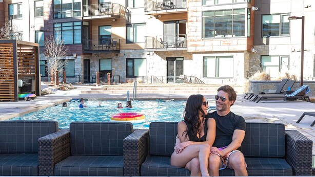 A pool area with lounge chairs and a fire feature. - LIFT 307-A | Ski-In/Out | Near Pool Deck | Mountain View | Hot Tub | Pool | Great Amenities (Park City)