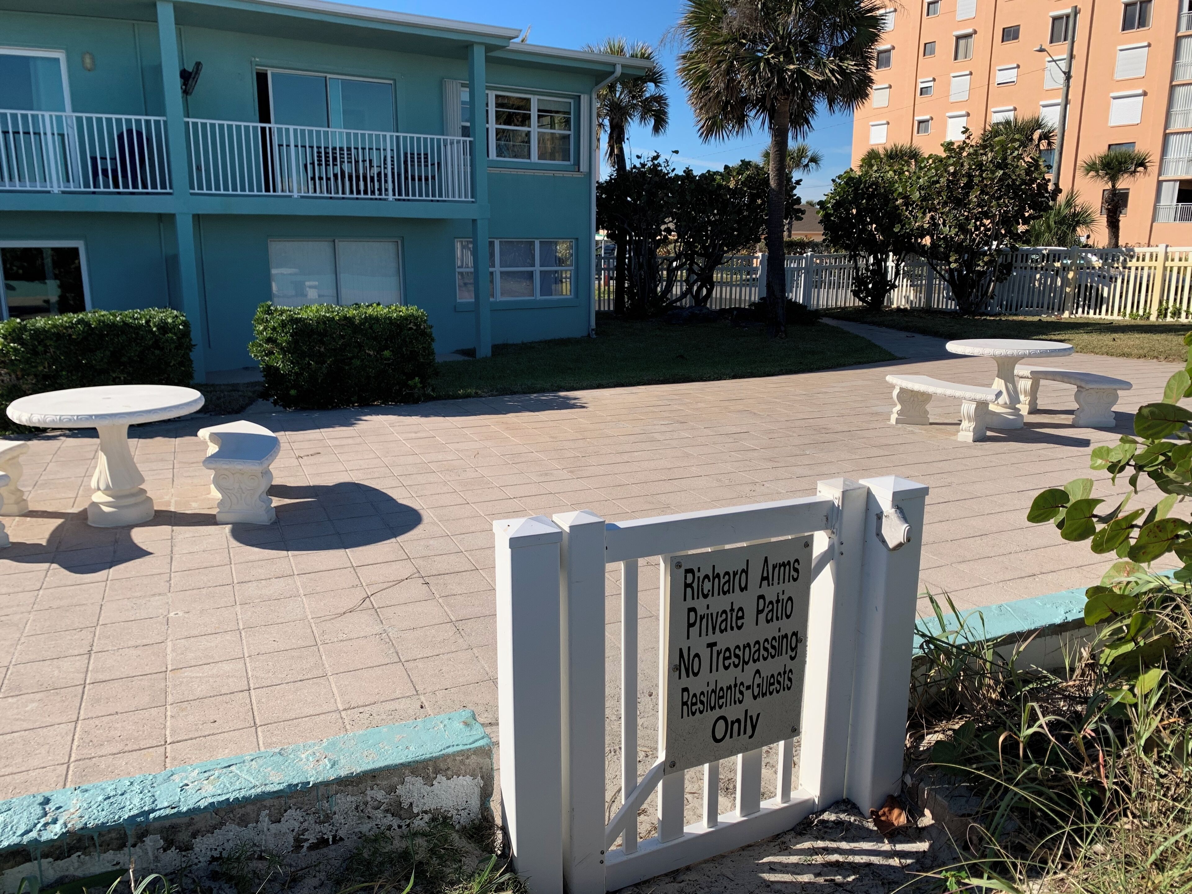 A private patio area with a sign indicating it is for residents and guests only.