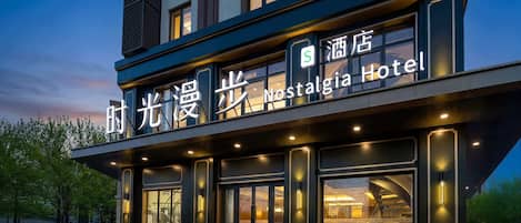 A hotel with a modern facade, large windows, and a sign indicating it is the Nostalgia Hotel.