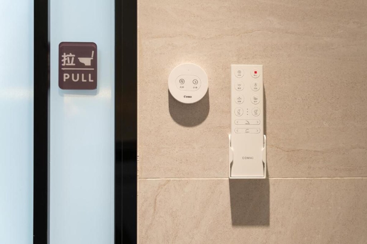 A control panel with a pull-down switch and a remote control.