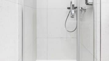 A modern shower with a handheld showerhead and a control panel.
