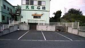 En byggnad med en skylt som visar texten "民宿石橋" (Minkan Shichiseki).