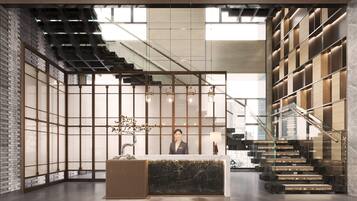 A modern reception area with a marble counter, a staircase, and a view of the city.