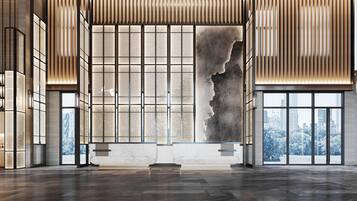 A spacious lobby with a large stone sculpture, wooden paneling, and a view of a cityscape through large windows.