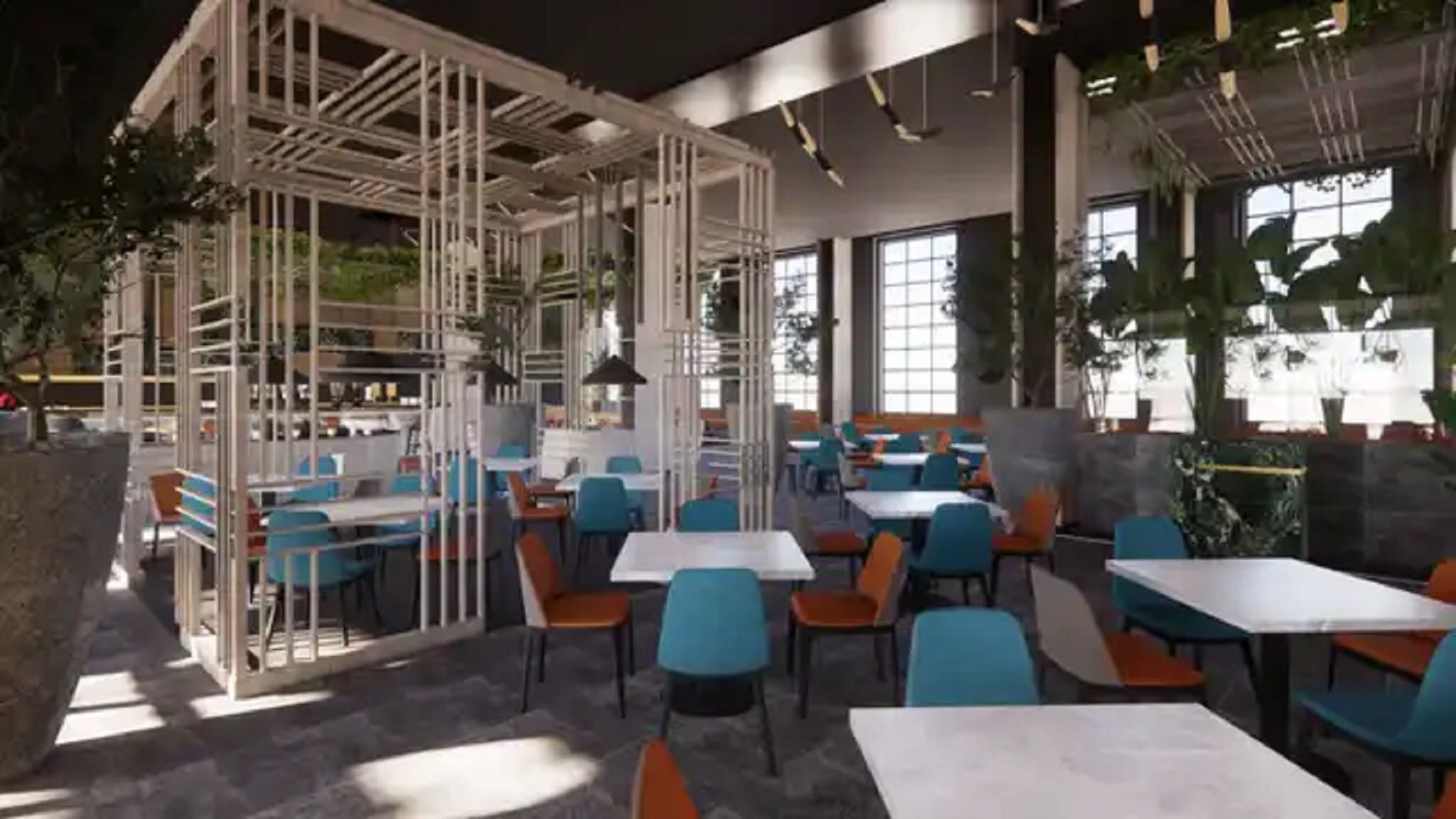 A modern indoor dining area with high ceilings, exposed structural beams, and a mix of blue and orange chairs.