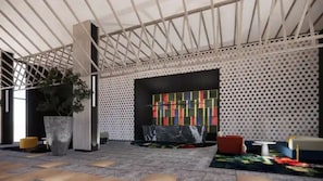 A spacious lobby with a high ceiling, a large potted plant, a colorful abstract painting, and a seating area with a sofa and a small table. - Aston Serang Hotel & Convention Center (Serang)