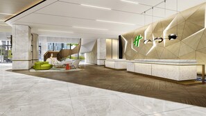 A modern lobby with a reception desk, seating area, and a geometric wall design. - Holiday Inn Xian East (Xi'an)